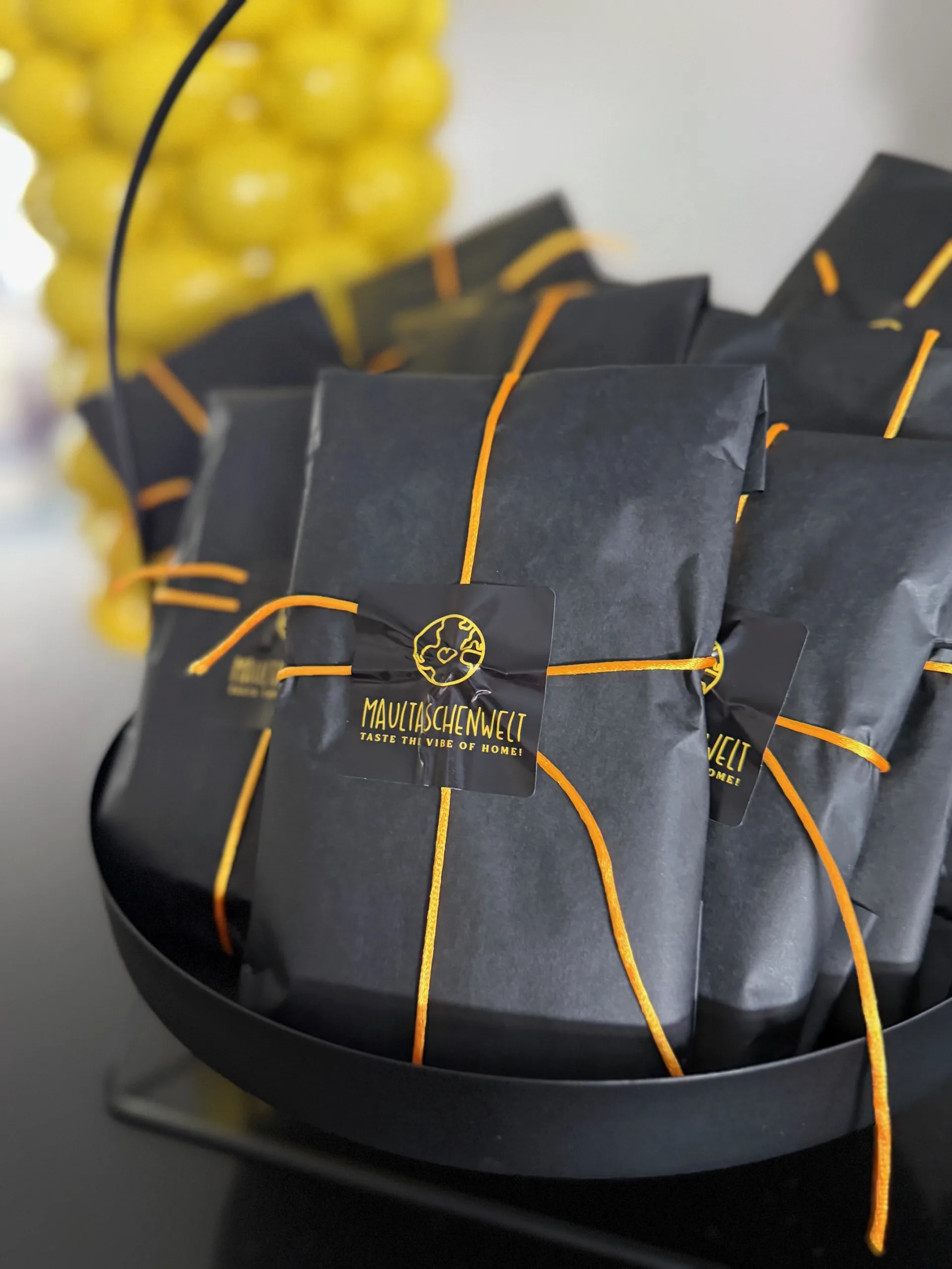 In schwarzem Papier mit goldenem Markensiegel verpackte Spezialitäten der Maultaschenwelt.